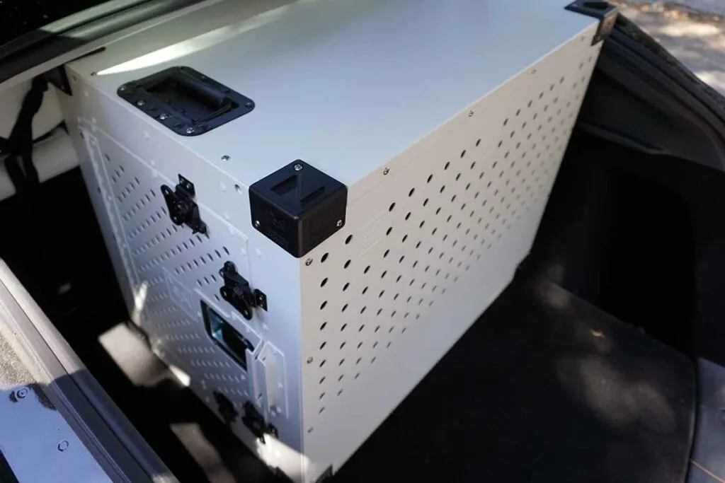 Impact High Anxiety Dog Crate (30-inch size) securely placed in the trunk of a Tesla Model Y, ideal for dogs with separation anxiety.
