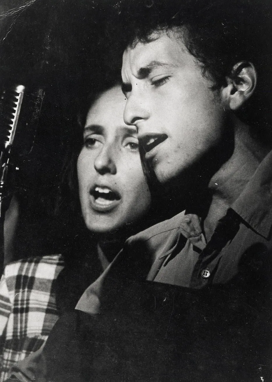 Joan Baez, the folk music icon, performing live, her expressive vocals harmonizing with the spirit of the era. A key figure in Bob Dylan's musical journey.