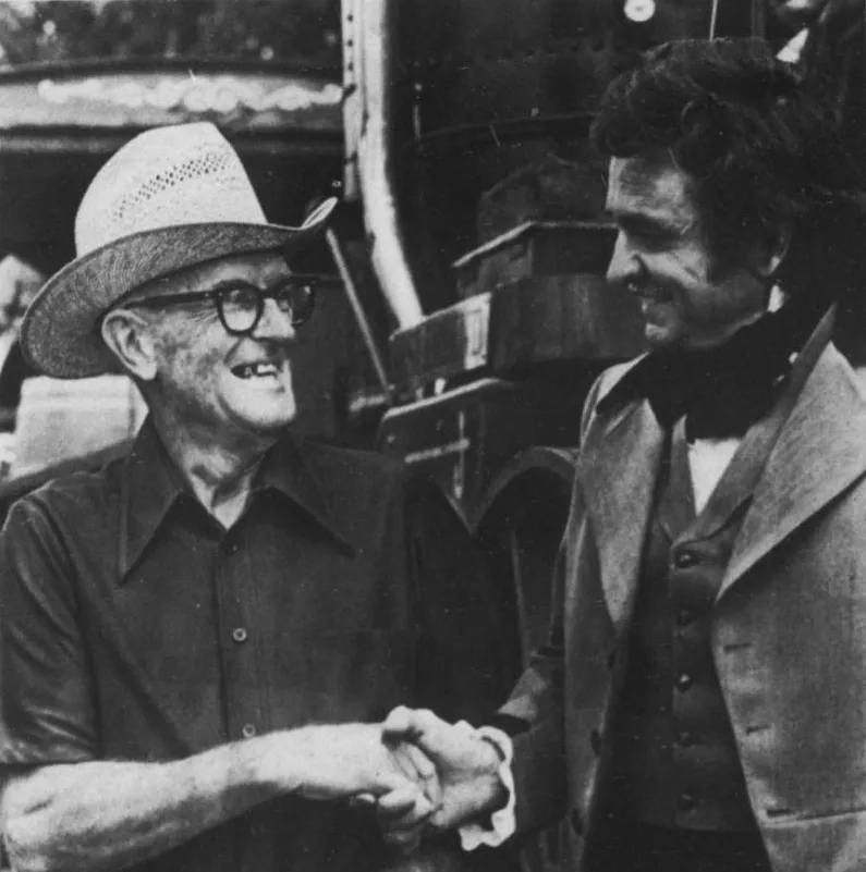 Johnny Cash shaking hands with landowner Melville Brown during the 1974 "Ridin' the Rails" filming in Pike County, Georgia.
