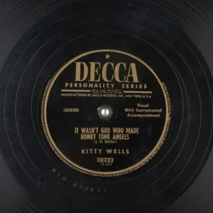 Kitty Wells, a pioneering female country music artist, whose song "It Wasn't God Who Made Honky-Tonk Angels" is recommended as a starting point for an essential country list.