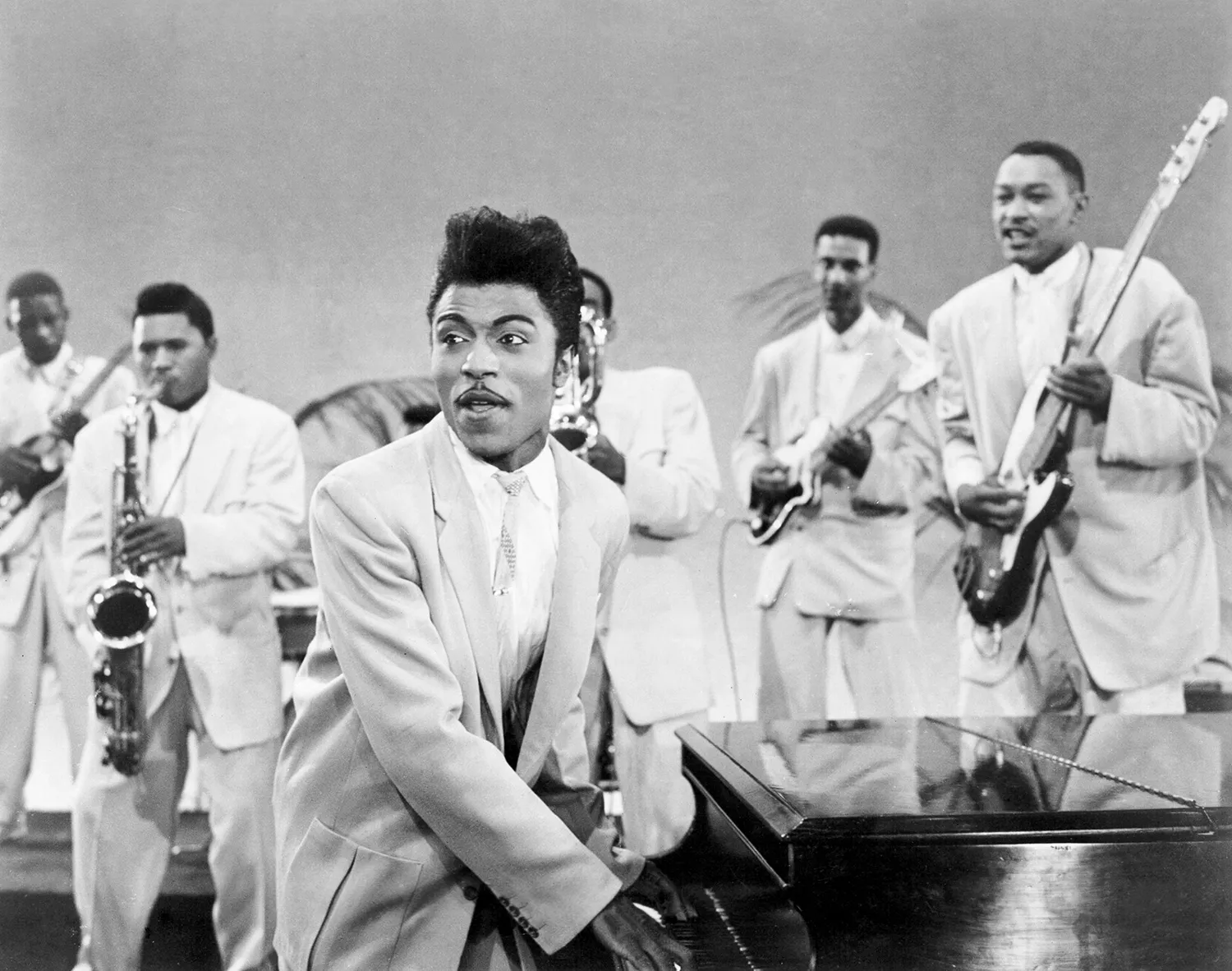 Little Richard, charismatic as ever, with a microphone, ready to deliver another powerful vocal performance that defined his influential career