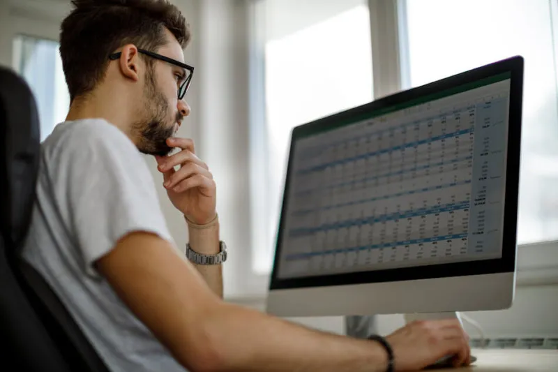 Man looking at spreadsheets