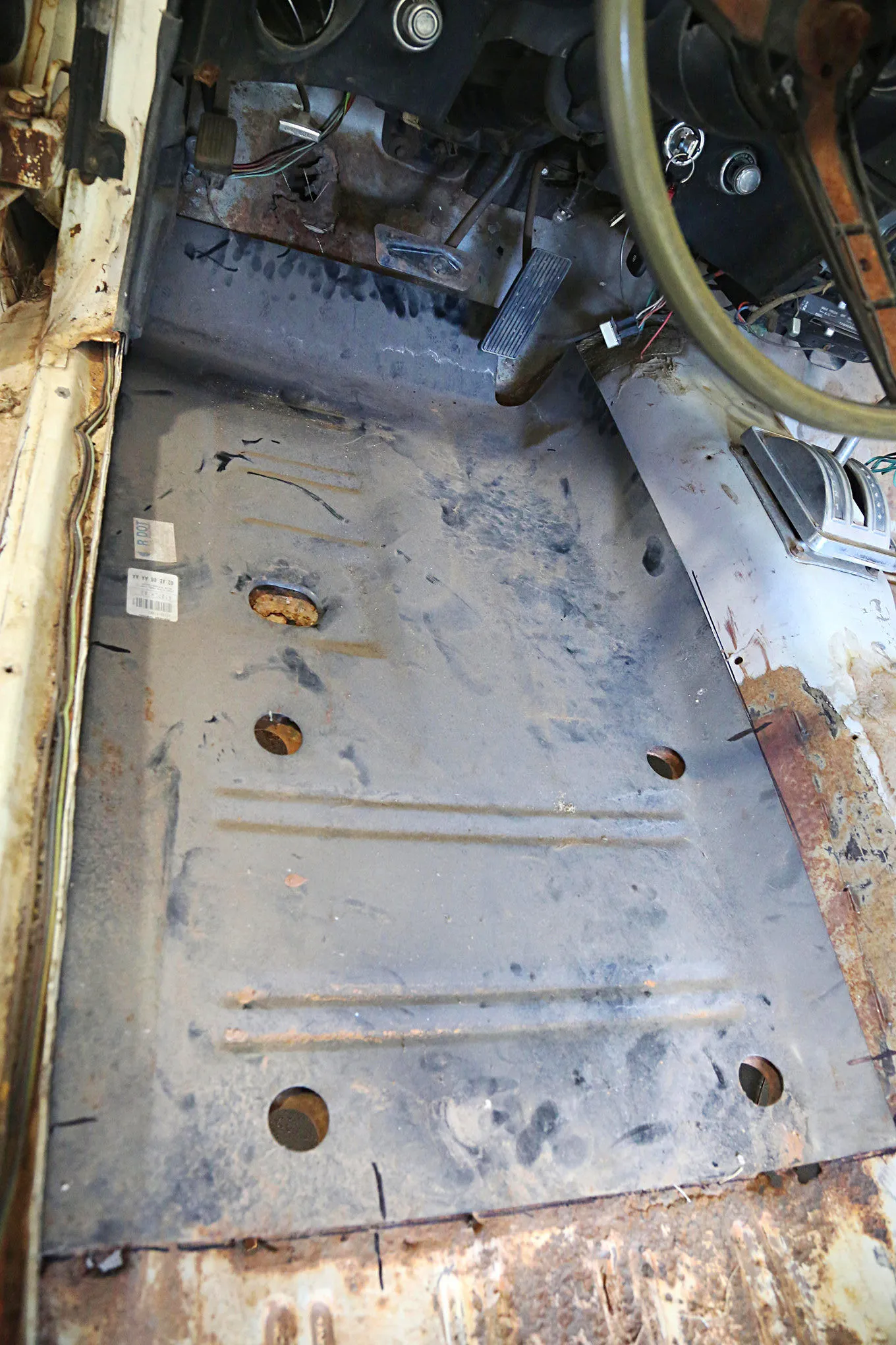 New floor pan patch panel from Summit Racing placed for test fit in a 1969 Mustang Coupe