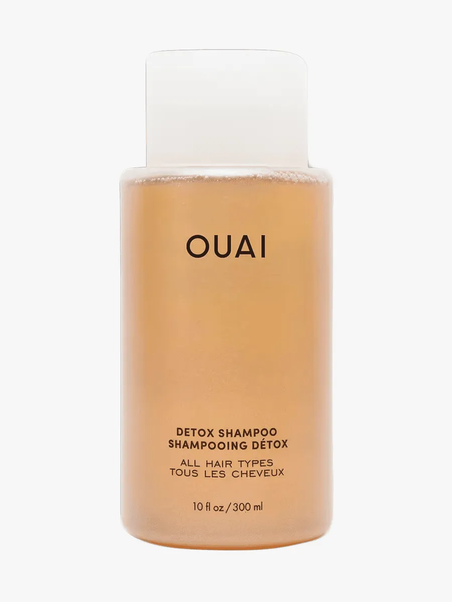 Ouai Detox Shampoo in clear bottle component with black accents on a light gray background