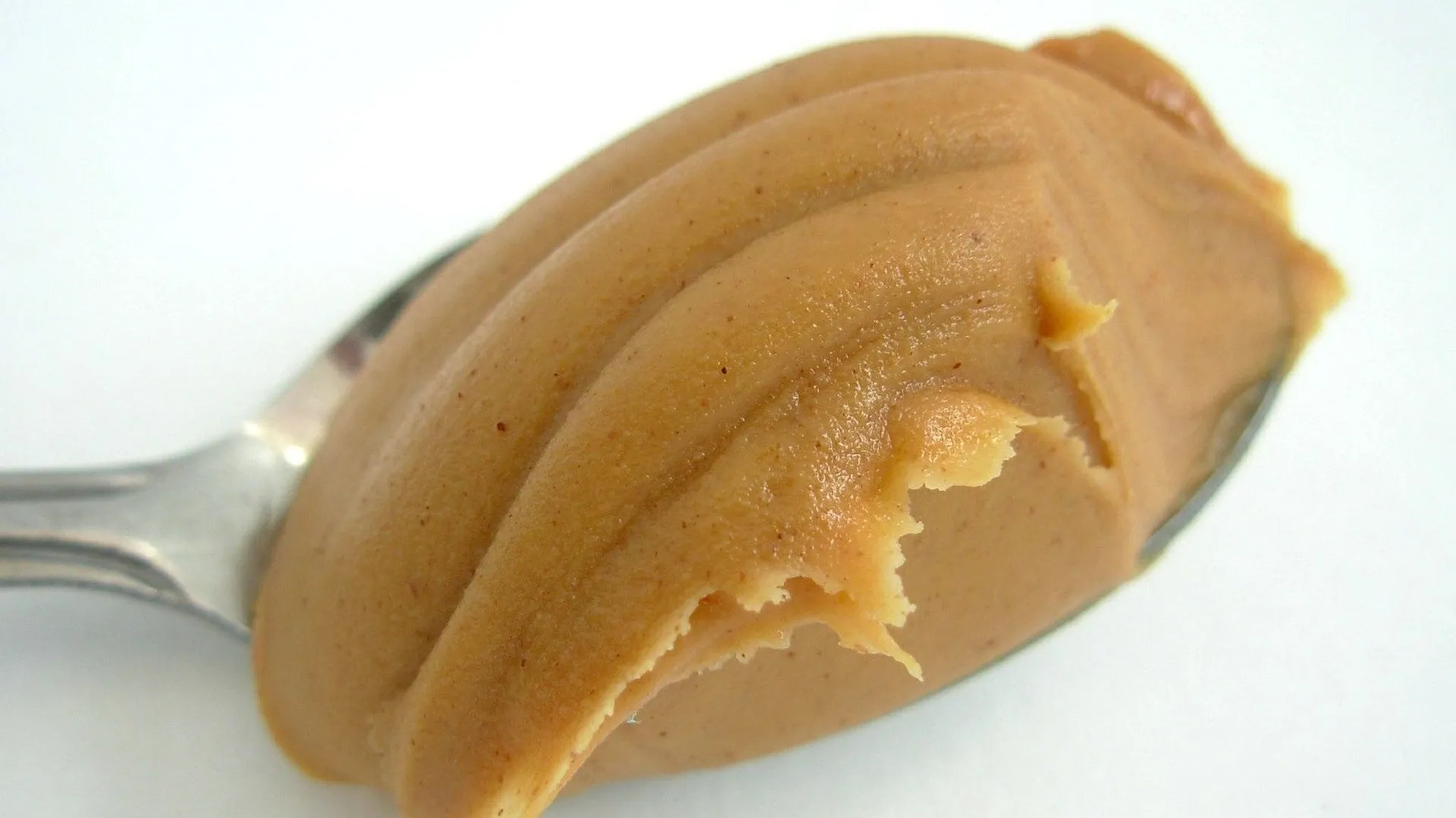 Peanut butter in a jar with a spoon, a popular dog treat