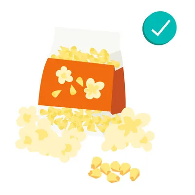 Popcorn and corn on the cob, showing grains that are safe for dogs when prepared correctly