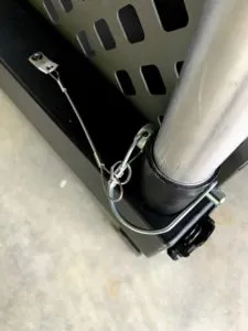 Portable grooming arm folded into the rail of an Impact Dog Crate for convenient storage and transport.