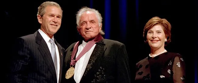 President George W. Bush and Mrs. Laura Bush presenting Johnny Cash with the 2001 National Medal of Arts.
