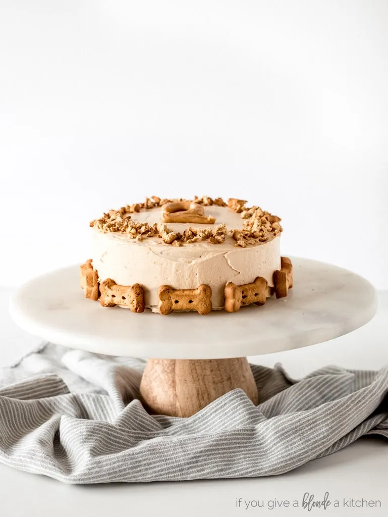 Pumpkin dog cake decorate with biscuits on a cake stand
