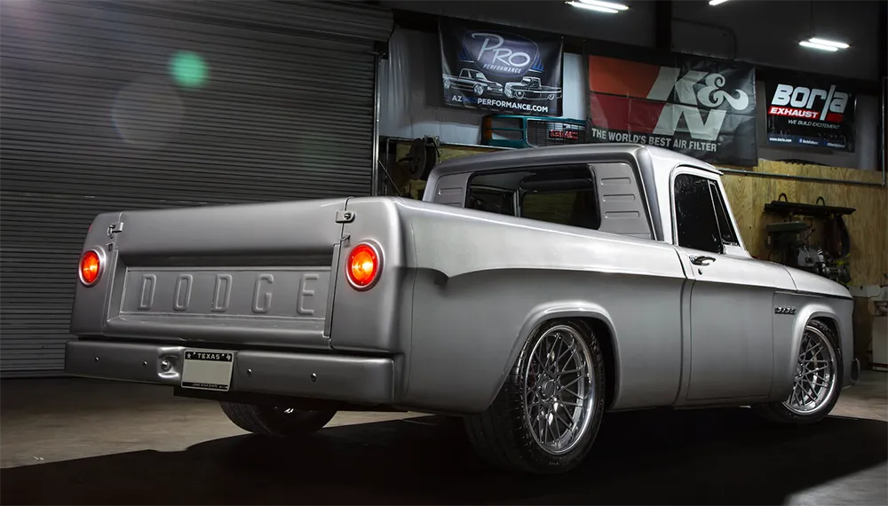 Rear view of the customized 1962 Dodge D100 Sweptline resto-mod, showcasing its unique modifications like RideTech coilovers and American Racing wheels, a prime example of a revitalized old Dodge truck