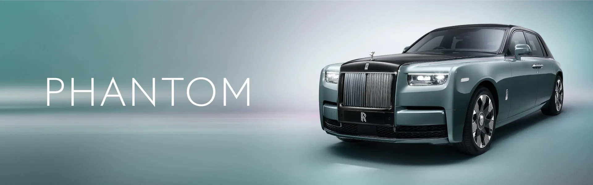 Rolls-Royce Phantom luxury sedan in dark blue, showcasing its elegant profile and iconic Spirit of Ecstasy emblem
