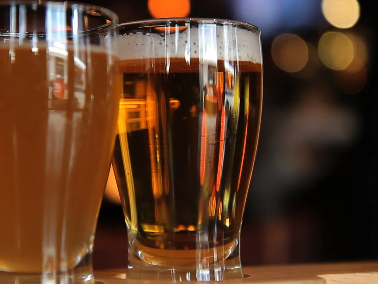 Several glasses of beer on a table.