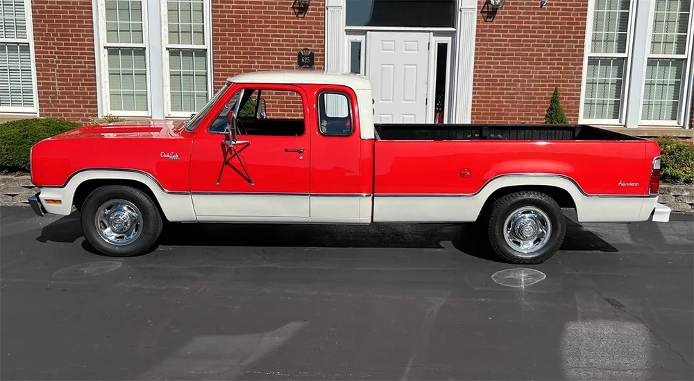 Side view of a 1974 Dodge D200 Club Cab pickup, featuring its pioneering extended cab design with small side windows and rear jump seats for additional passengers