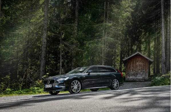 Side view of a modern grey Volvo luxury sedan, reflecting its understated Scandinavian design and safety focus.