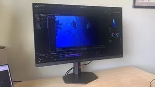 The AOC Gaming Q27G4ZR monitor on a desk, showcasing its sleek design and large display for gamers and creatives