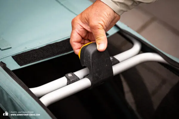 The Burley dog bike trailer is easily folded with a single handle, showcasing its convenient design.
