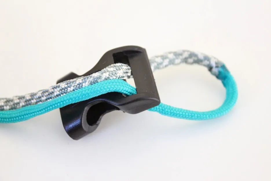 The D-ring is added, and both paracord ends are threaded through the second buckle.