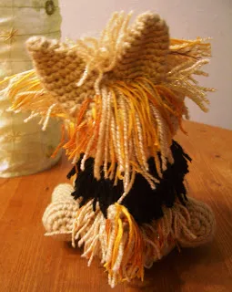The distinctive silken coat of a Yorkshire Terrier, shown from the back, requiring regular grooming.