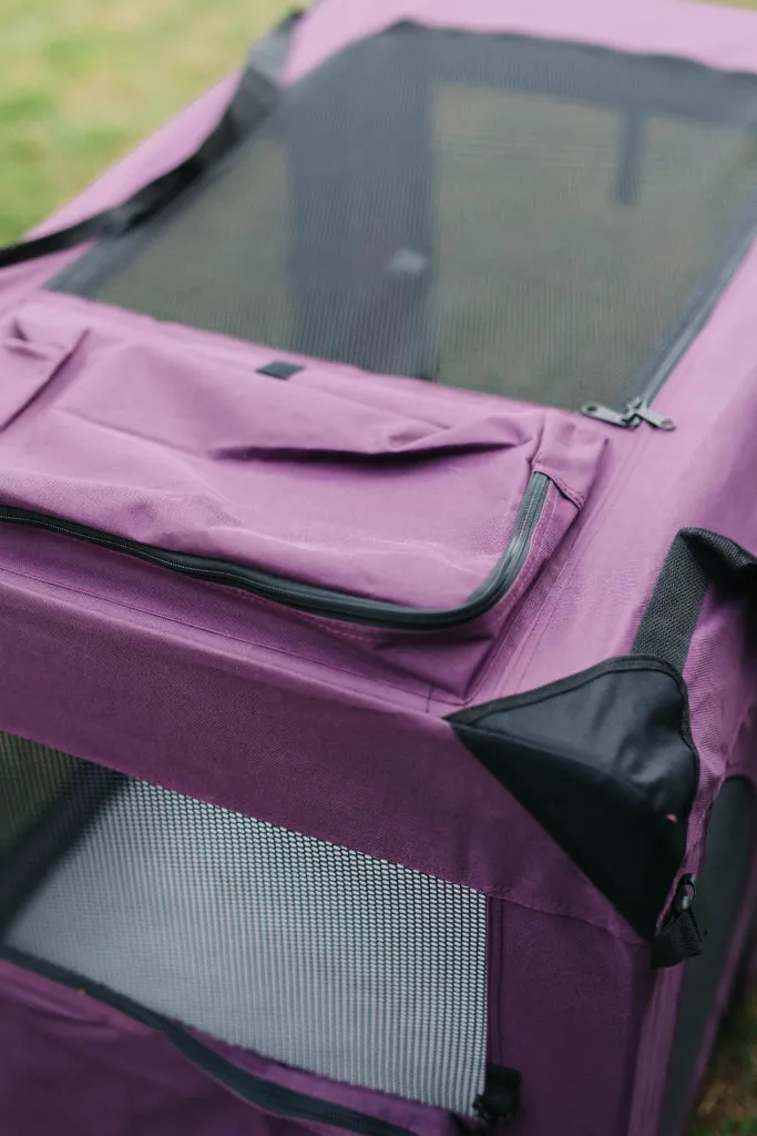 The EliteField soft sided dog crate neatly folded and secured in its carrying bag, complete with a convenient shoulder strap for transport.
