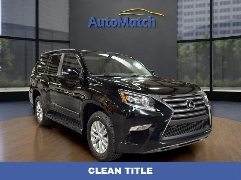 The luxurious interior of a 2014 Lexus GX 460, showcasing the leather seats and wood trim.