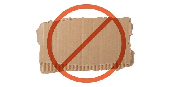 Torn cardboard pieces, illustrating a common household item dogs might chew on, posing a blockage risk.