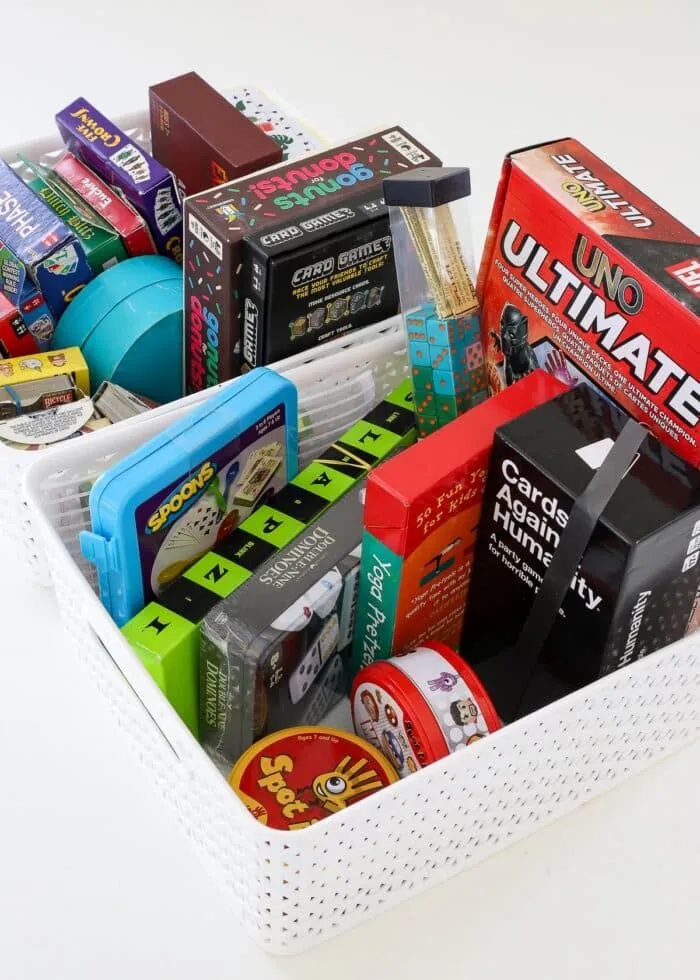 Two white baskets crammed full of small card games