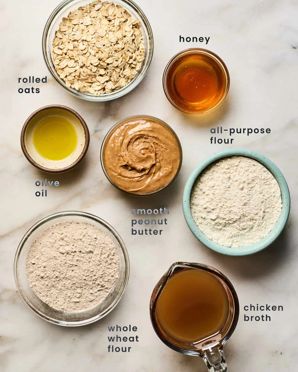Various ingredients for homemade dog treats laid out on a counter.