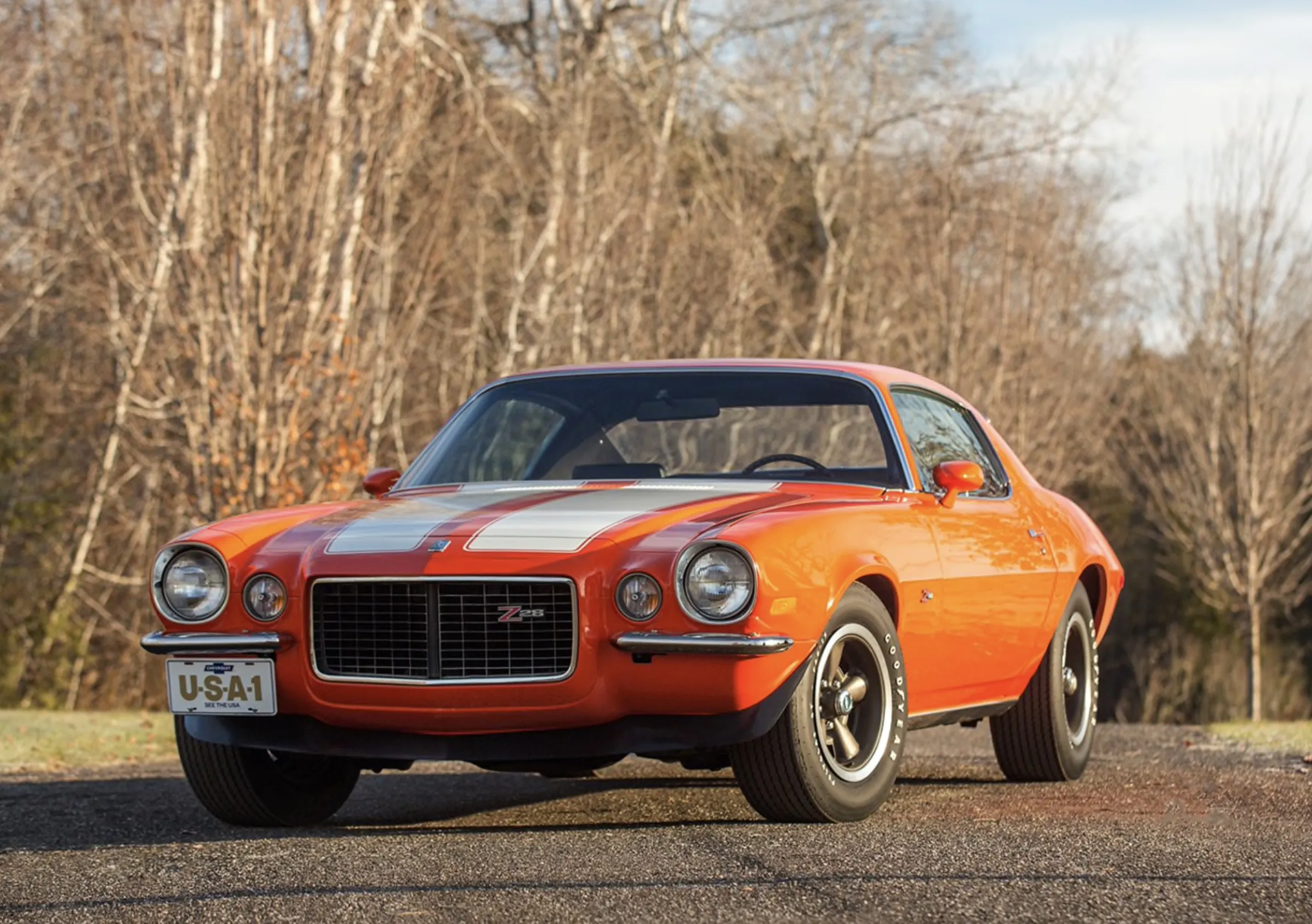 1970 Chevy Camaro front 3/4 view with its iconic split-bumper design in Hugger Orange