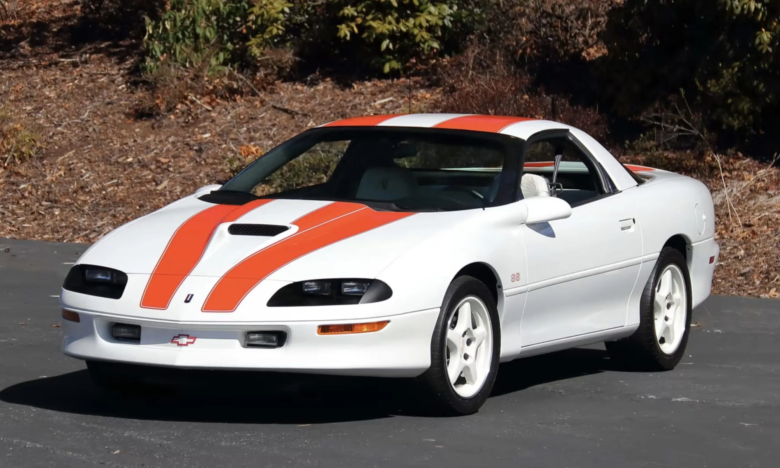 1997 Chevy Camaro SS 30th LT4 front 3/4 view, highlighting its white exterior and orange stripes