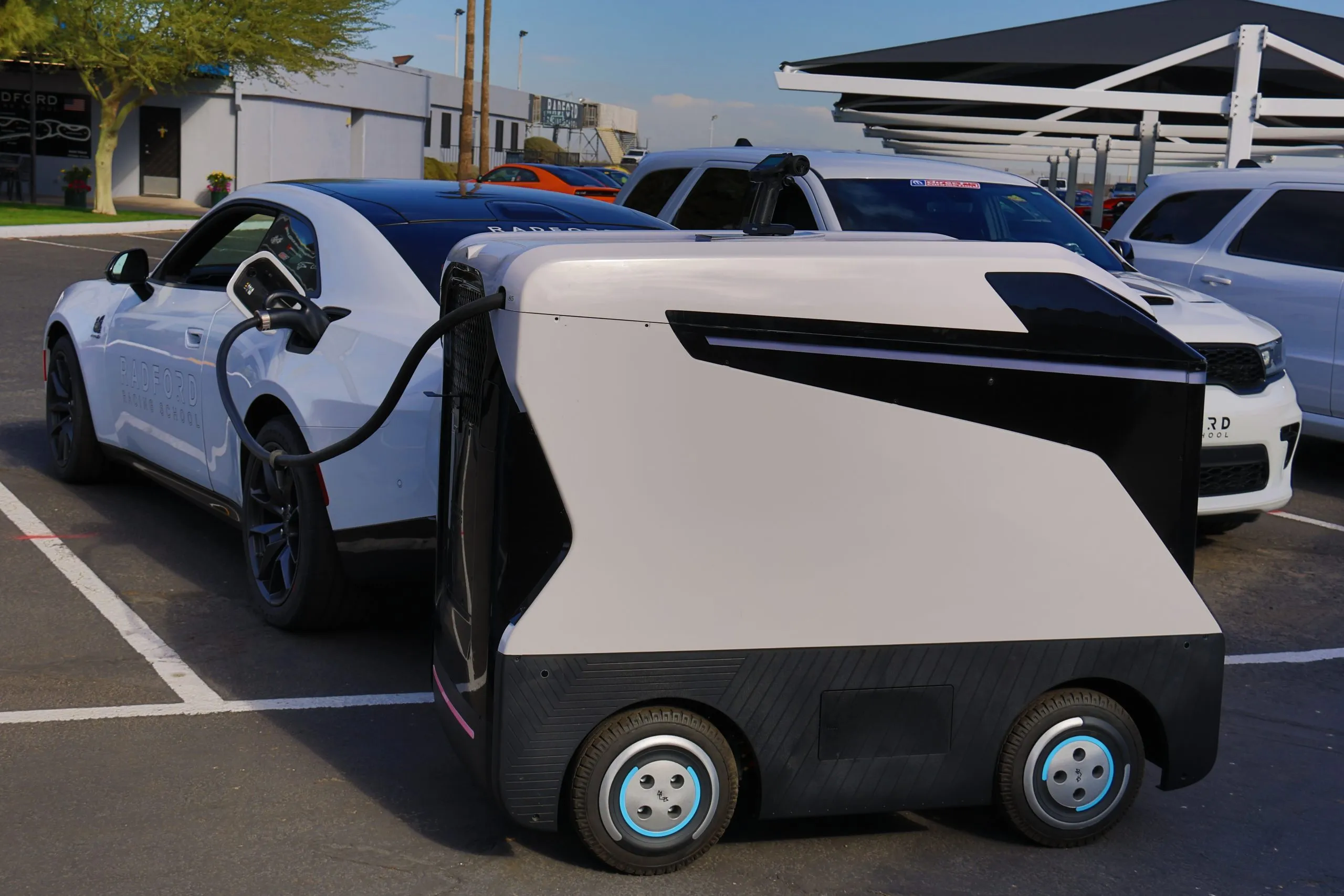 A 2024 Dodge Charger Daytona being charged by a mobile DC charger from Ion Dynamics