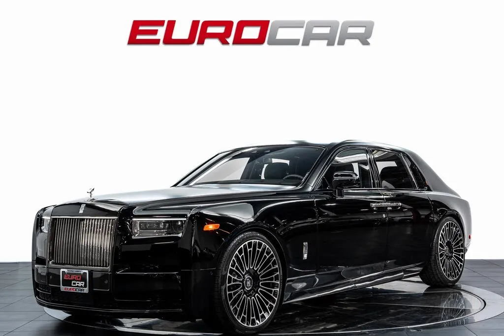 A black 2024 Rolls-Royce Phantom RWD, showcasing its elegant exterior design.