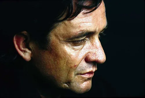 A black and white photo of Johnny Cash, emphasizing the "blackness" that contained multitudes.