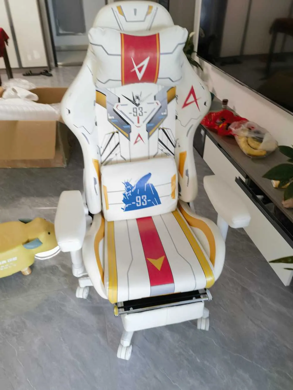 A black Custom Pro Max chair with bright blue accents and stitching, seen from a side-front angle
