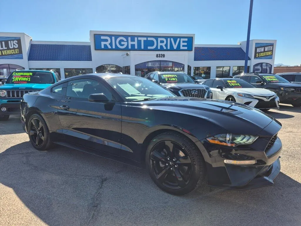 A blue 2021 Ford Mustang EcoBoost Coupe, showcasing its sleek design and aggressive front grille