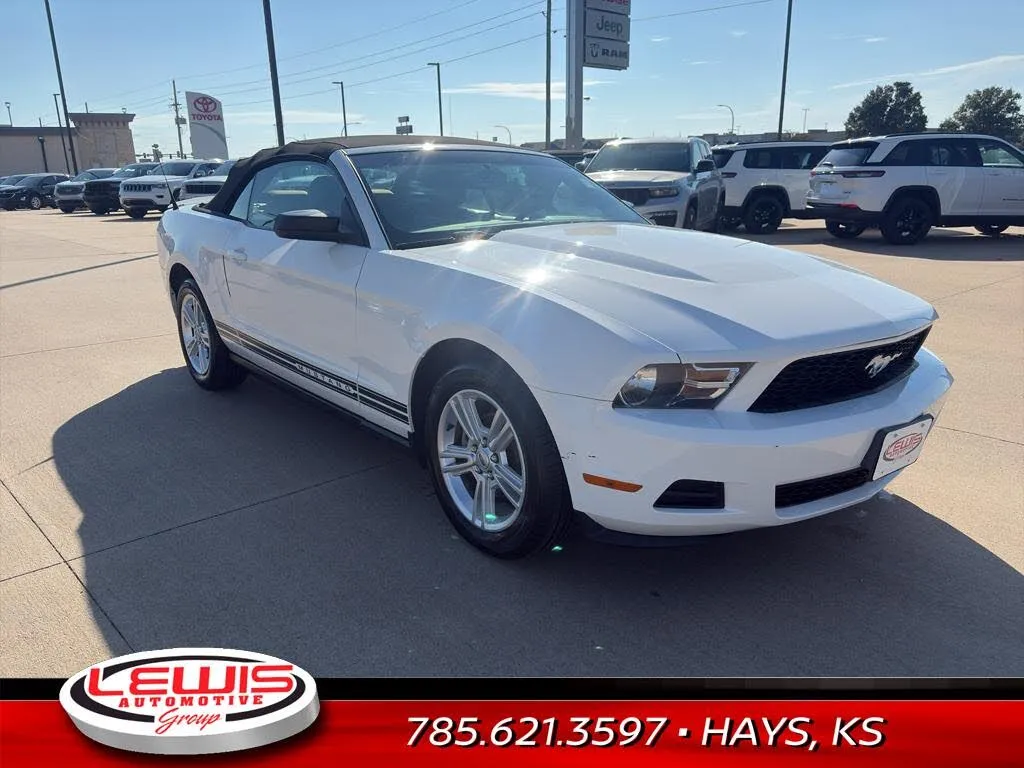 A bright white 2010 Ford Mustang V6 Convertible, showcasing its classic American sports car lines.