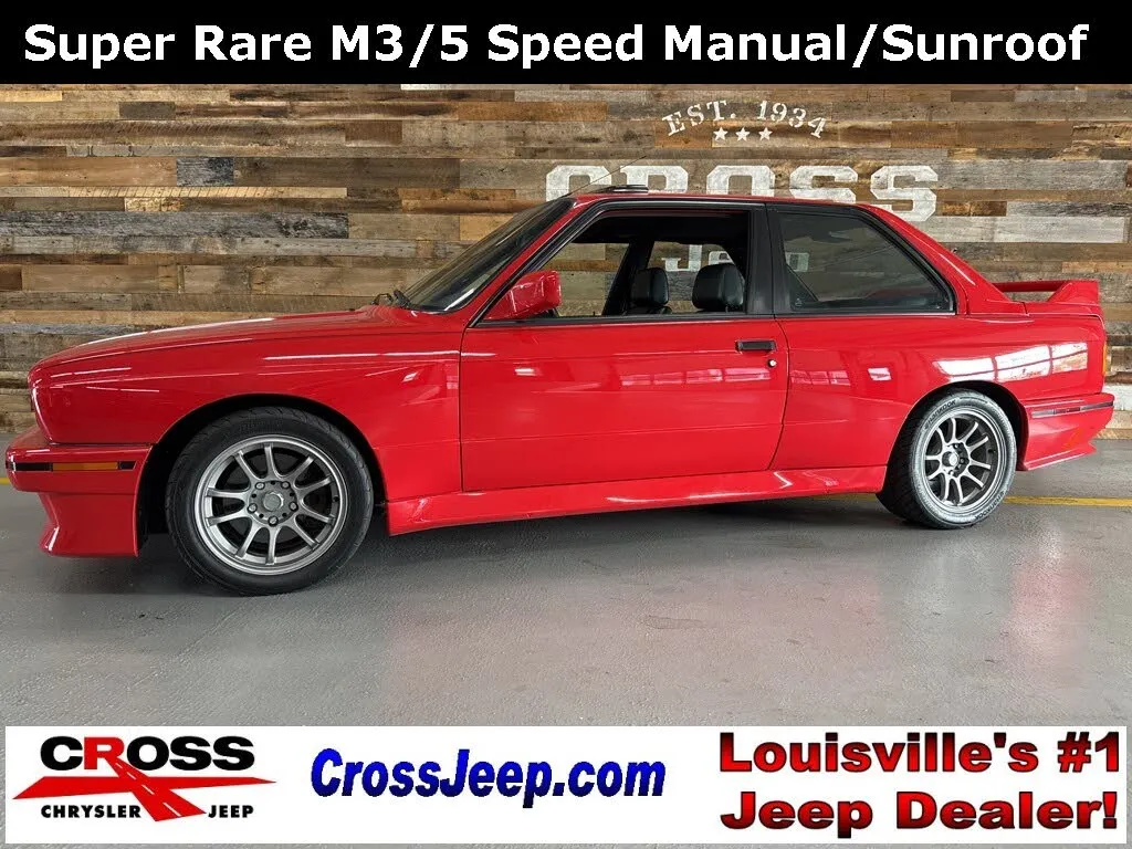 A classic 1990 BMW E30 M3 coupe in red
