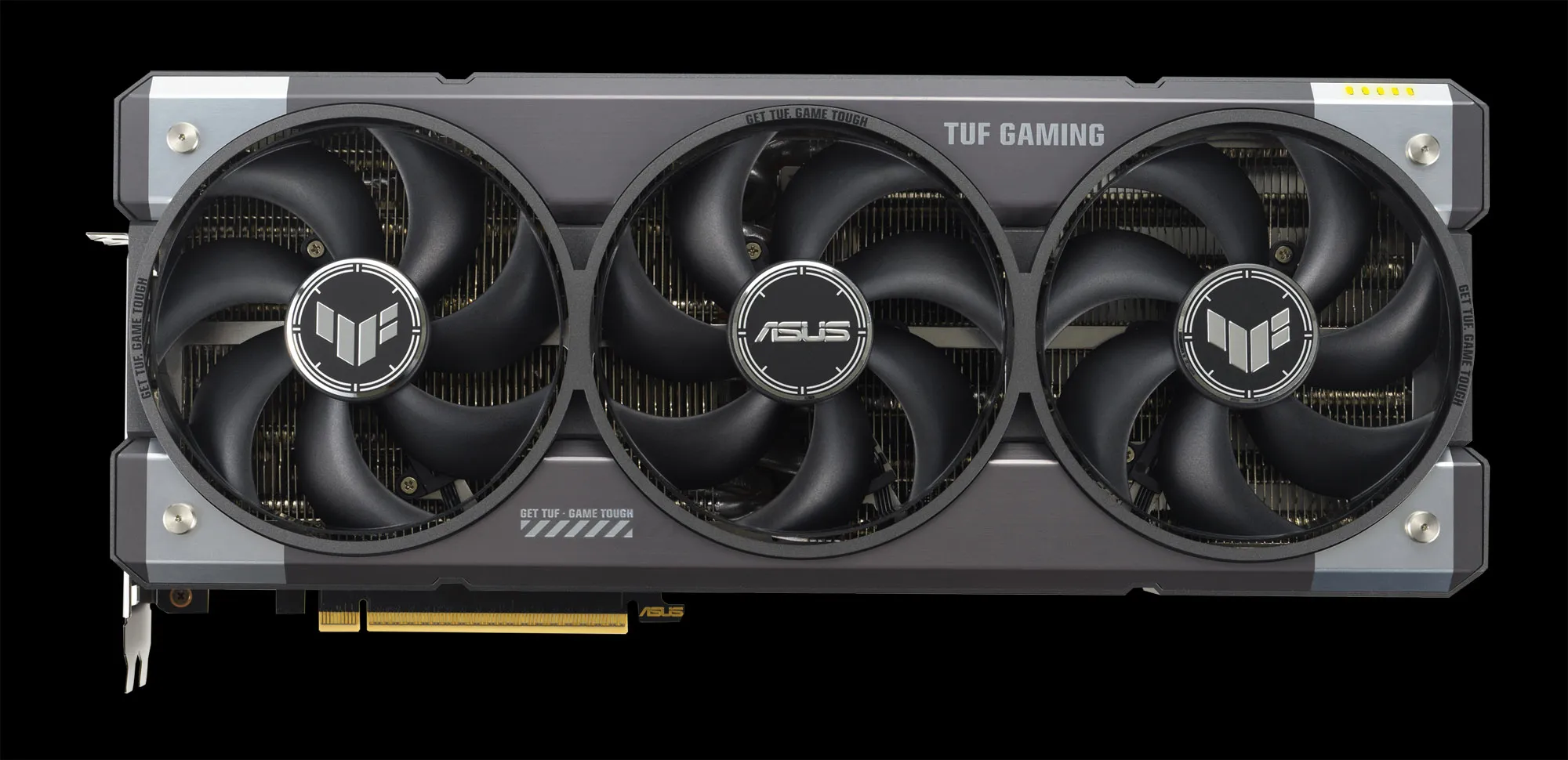 A close-up shot of an ASUS TUF Gaming GeForce RTX 5080 graphics card showcasing its robust triple-fan cooler and military-grade aesthetic.