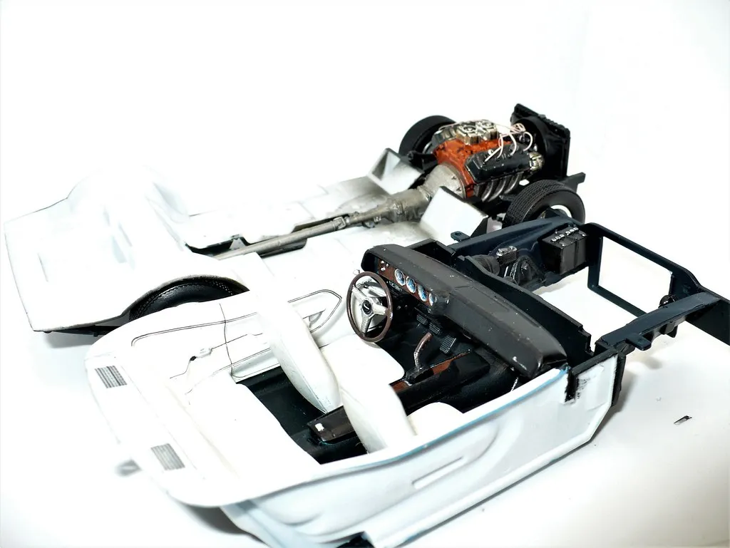 A detailed interior view of the 1970 Plymouth Cuda Hemi model, featuring the striking white and black color scheme with subtle weathering.