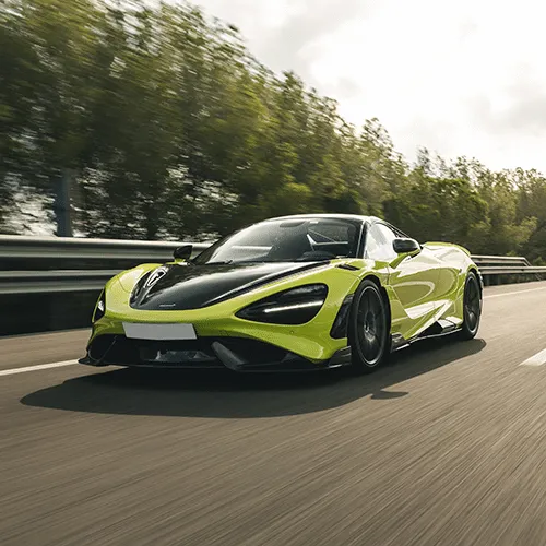 A dynamic shot of a McLaren 765LT, highlighting its aggressive styling and aerodynamic features