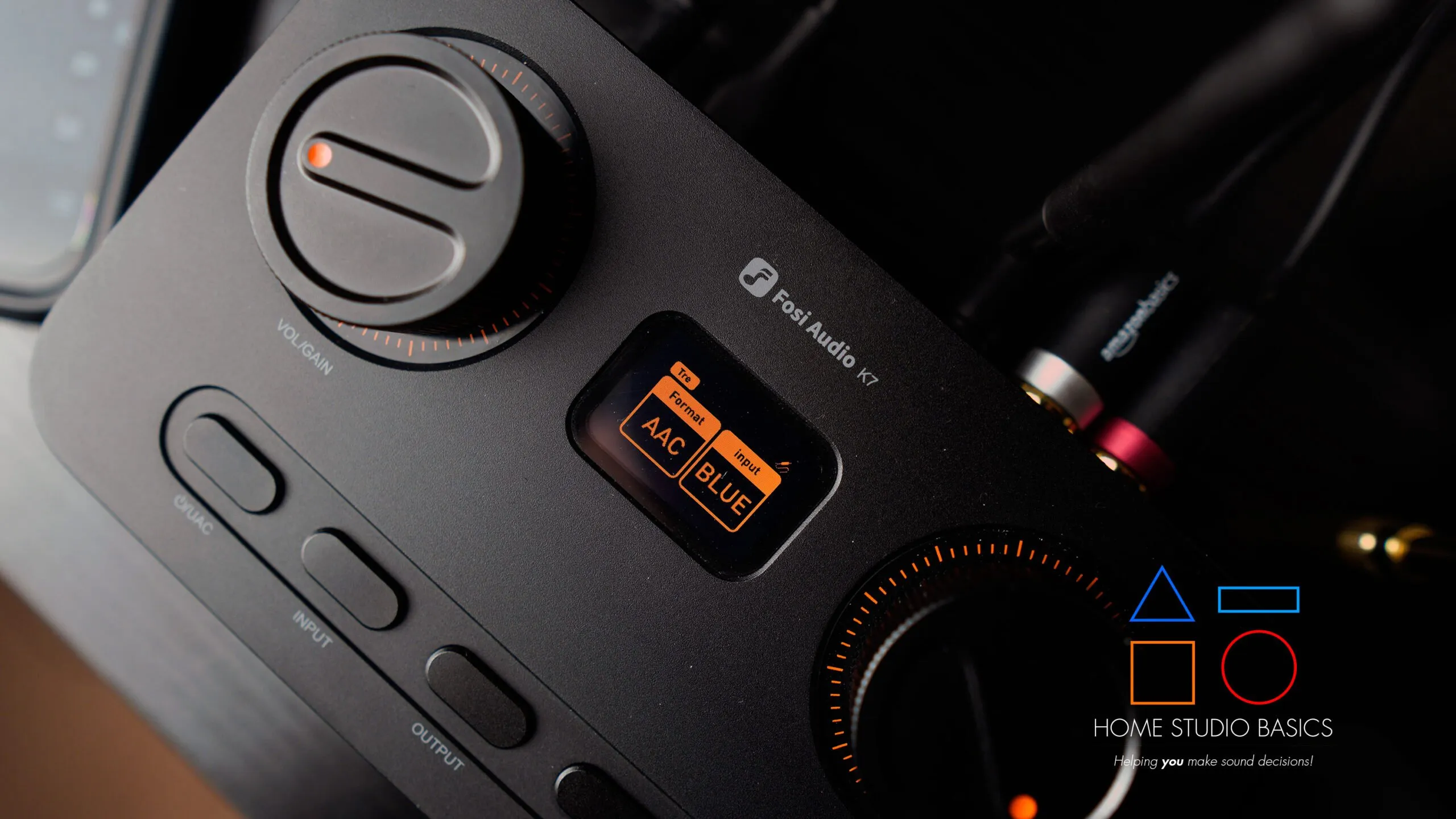 A Fosi Audio K7 Gaming Headphone Amp and DAC, showcasing its front panel controls