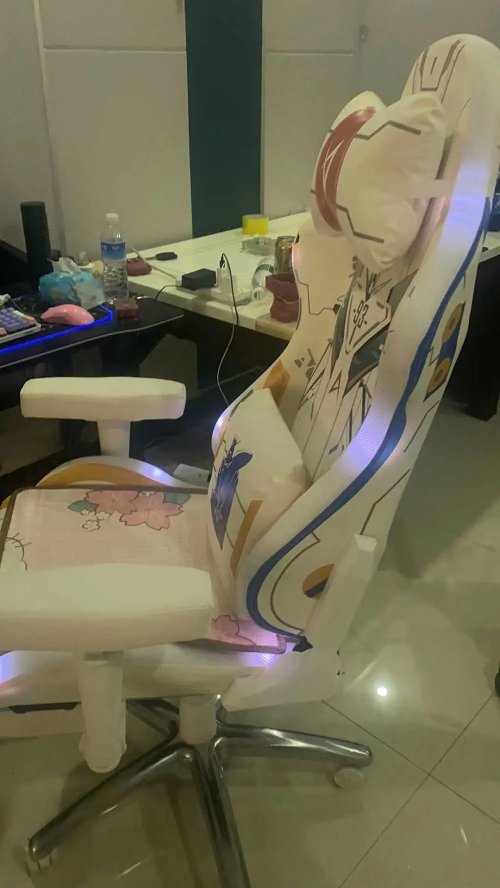 A gamer's Custom Pro Max chair featuring a dark gray backrest and red accents, seen from the front