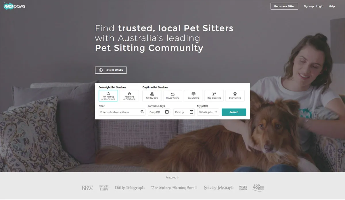 A happy dog and cat playing together on the Mad Paws homepage, with a prominent search bar