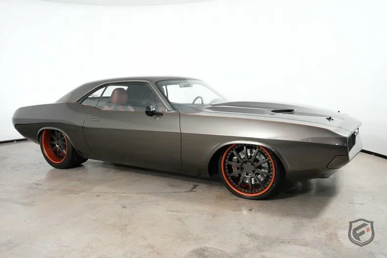 A meticulously restored 1970 Dodge Challenger in a vibrant shade of brown