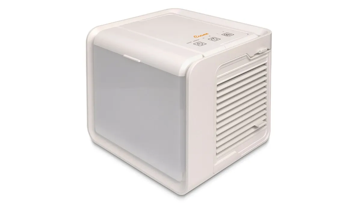A person using a portable air cooler on their desk.