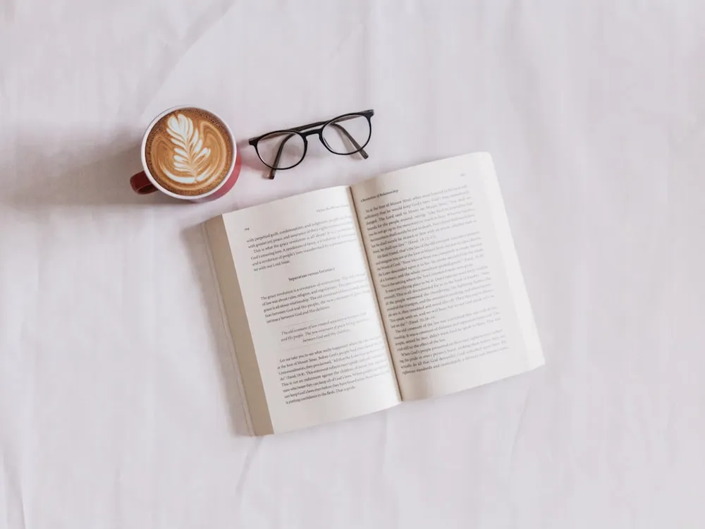 A photograph of a person reading a book, representing the act of engaging with a story