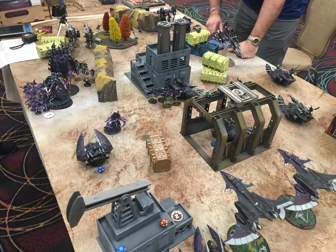 A photograph of a wargaming table with miniature buildings marked with numbers.