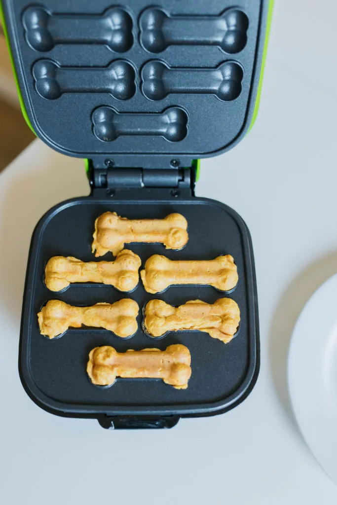 A plate full of golden-brown dog pancakes, ready to be served.