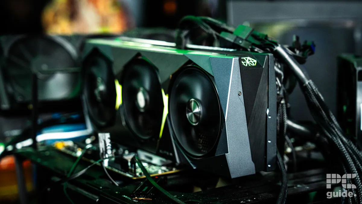 A silver GeForce RTX graphics card plugged into a motherboard and turned on. It