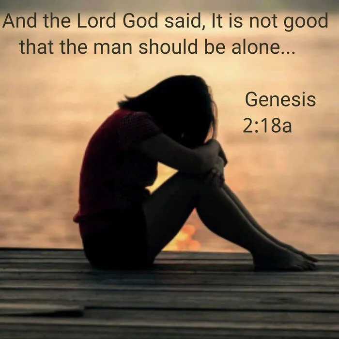 A solitary figure with head bowed, illustrating the profound feeling of loneliness.