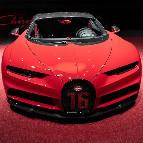 A striking blue Bugatti Chiron parked on a futuristic-looking bridge